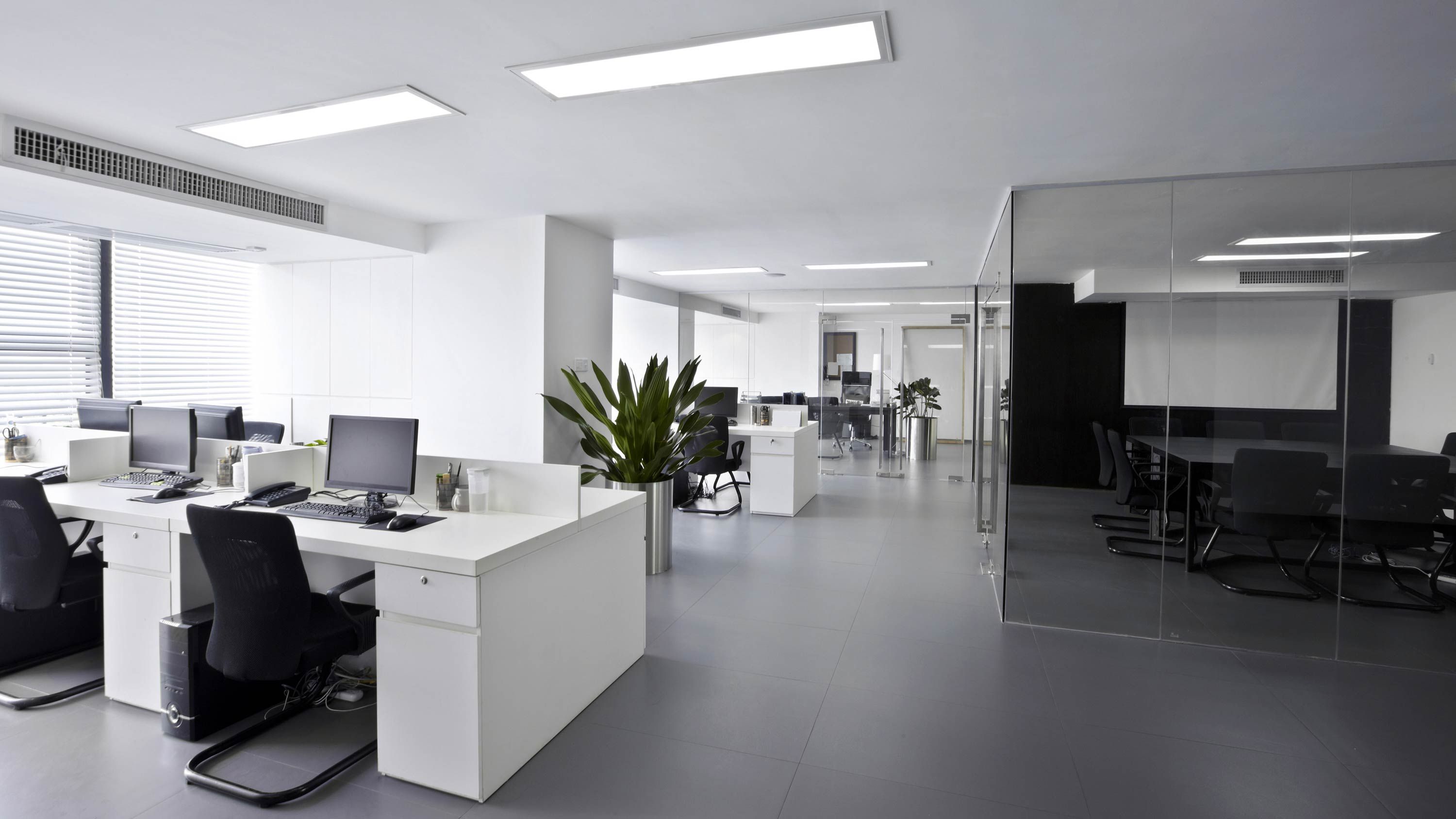 office with white desks, hvac control, lighting on ceiling