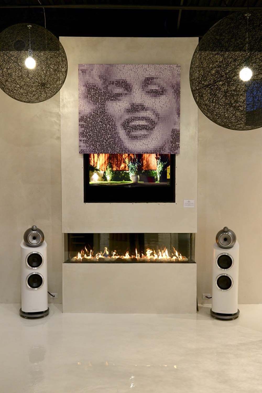 picture of marilyn monroe over fireplace with high performance audio