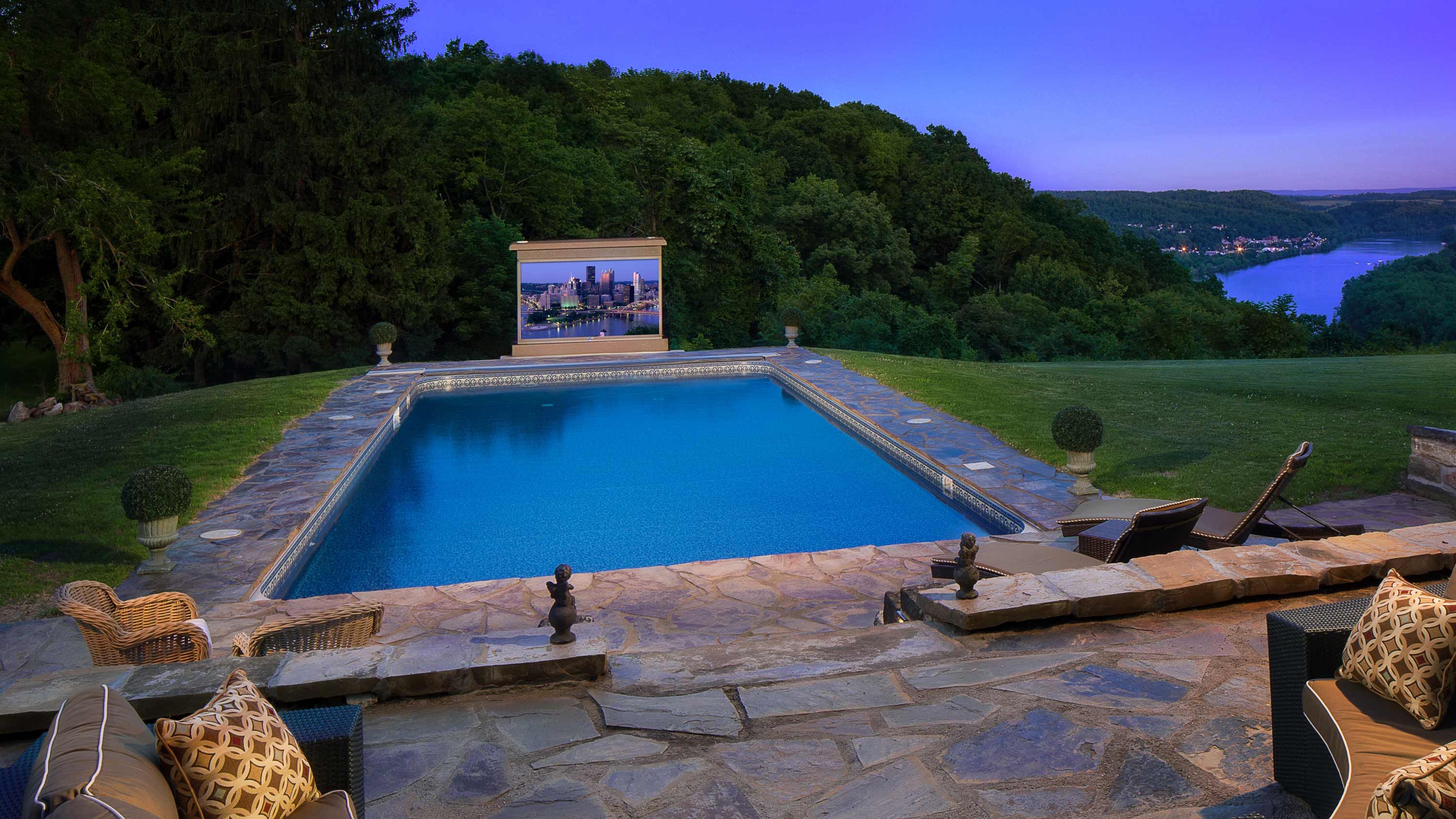 pool with tv, looking over yard and river
